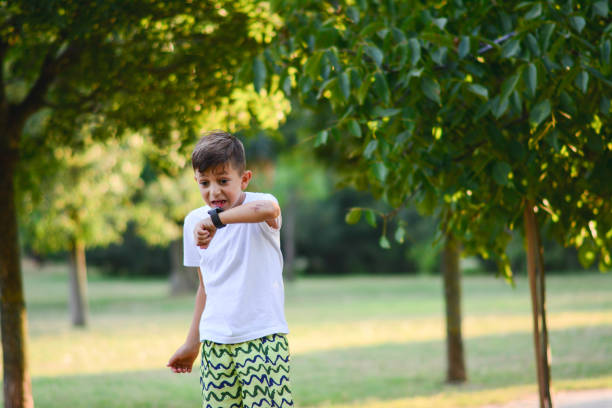 istock A cute boy looking at his smart watch touching the screen in park. A child using electronic device. Lifestyle concept 1254251101