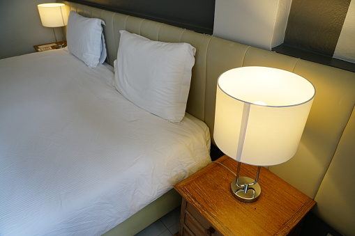 Close-up Classic lamp on wooden table side in bedroom.