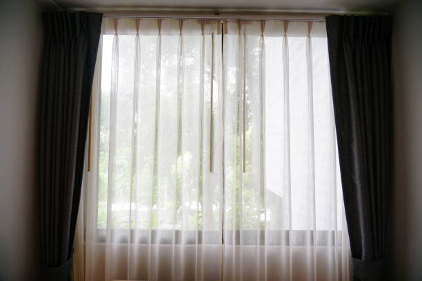 istock White curtain hanging in the window 1254254729