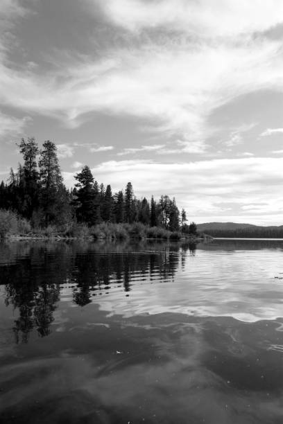 istock Black & white ocean and lake scenes with dynamic active cloudy skies and water reflections 1254254770