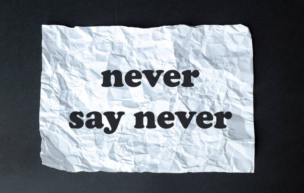 istock black calculator with text never say never on the white background 1254257404