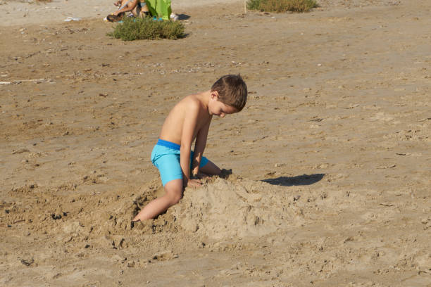 istock Child playing on the beach 1254261881