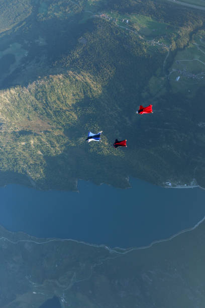 Wing suit fliers glide through clear skies