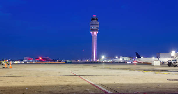istock Air Traffic Control Tower after with fueling trucks on a soft blue night sky. 1254263737