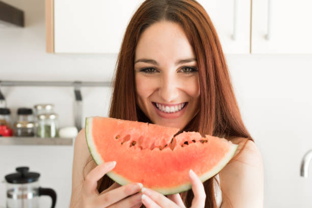 istock Woman eating watermelon 1254266989