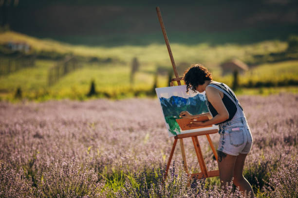 istock Female painter painting on lavender field 1254268330