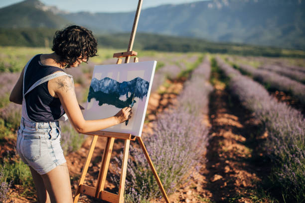 istock Female painter painting on lavender field 1254268372