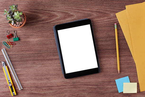 istock Tablet with a Blank Screen on Wooden Table on an Office Workspace. 1254268687