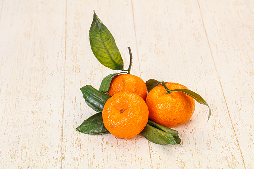 Ripe sweet tasty tangerine with green leaves