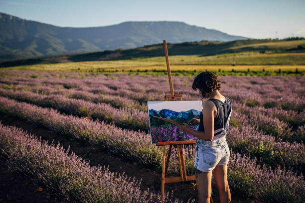 istock Female painter painting on lavender field 1254268773