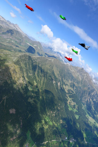 istock Wing suit fliers glide through clear skies 1254268799