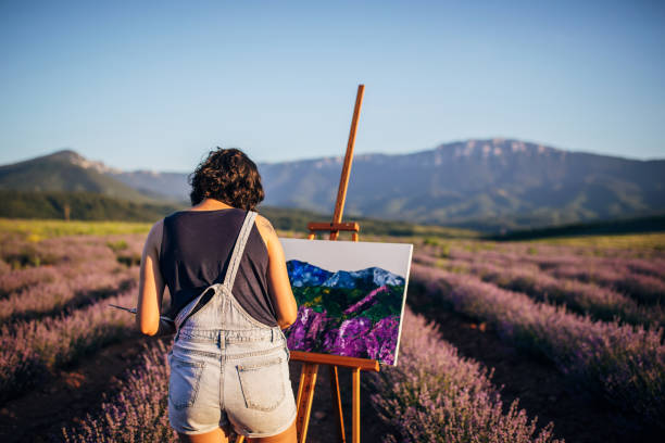 istock Female painter painting on lavender field 1254268837