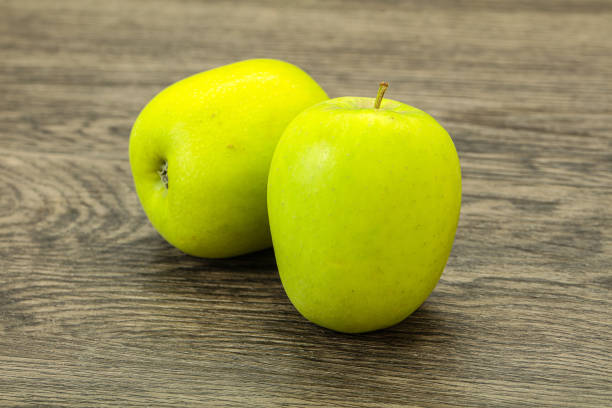 istock Two ripe green sweet apples 1254268996