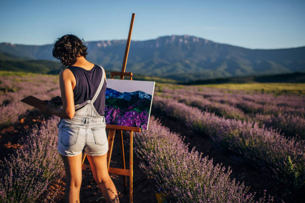 istock Female painter painting on lavender field 1254269259