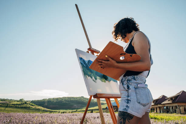 istock Female painter painting on lavender field 1254269496