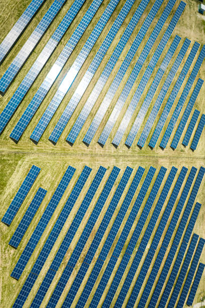 istock Solar panels on green field, aerial view 1254272406