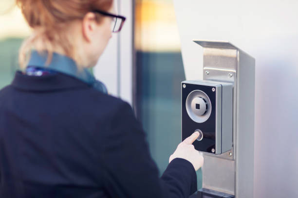 istock Woman using an intercom at an office building entrance 1254272942