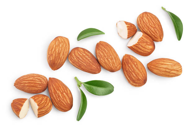 istock Almonds nuts with leaves isolated on white background with clipping path and full depth of field. Top view. Flat lay 1254274011