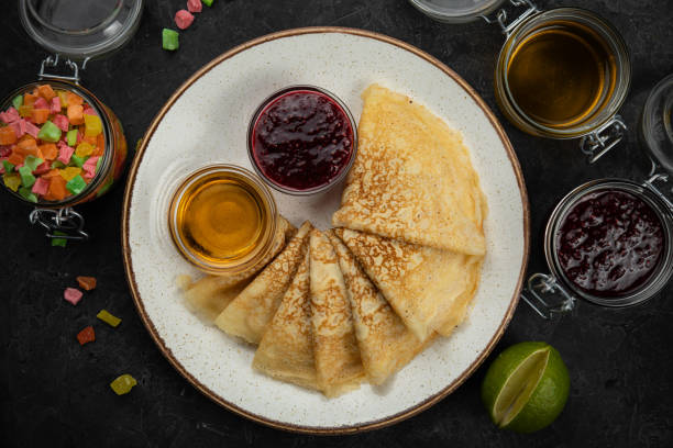 istock Pancakes with honey, jam and candied fruit 1254274296