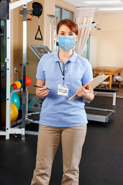 istock Physical Therapist Wearing Protective Face Mask In Clinical Setting 1254276700