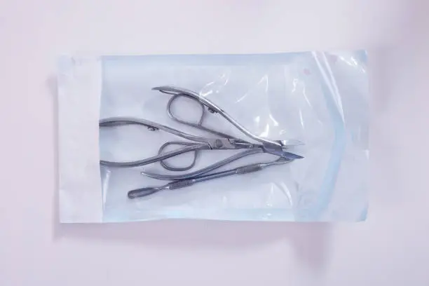Photo of sterilized tools for manicure and pedicure in sterile transparent packaging.