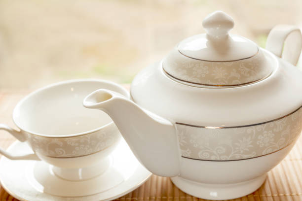 istock A cup on a saucer and a teapot on a table in the morning 1254277150