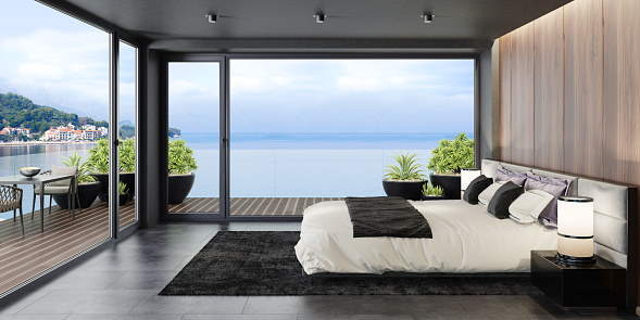 Modern matte black interior with mountain natural stone rock wall concept. Apartment master bedroom interior.\nModern king size bed with black gloss side tables. \nBlack carpet and ceiling with down lighters. Light stone marble flooring. 3d rendering.\n\n\n+++ seaside background is my photo