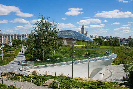 large glass dome of the greenhouse in Zaryadye Park. Panoramic view against a clear sky on a summer day and space for copying in Moscow Russia
