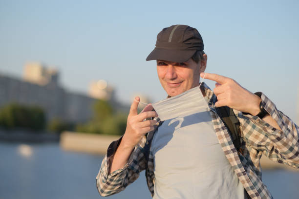 istock Man holding medical mask 1254279091