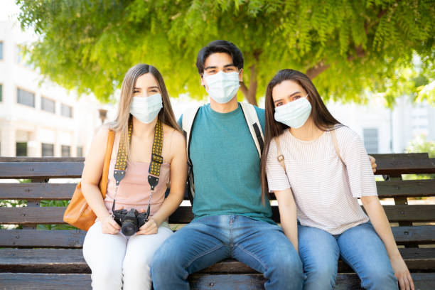 istock Young Friends Wearing Masks In Park 1254279282