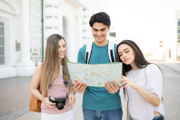 istock Tourists Reading Map In City 1254279415