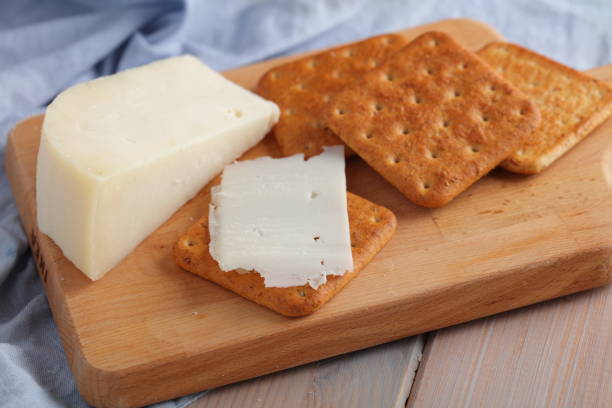 istock Crackers with Gouda Goat Milk Cheese on wooden board 1254279553