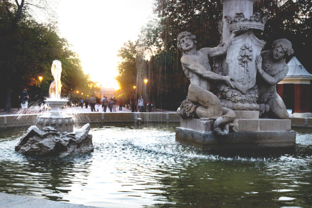 istock Fountain Alcachofa with sunset in background along path in park Retiro, Madrid, Spain 1254280733