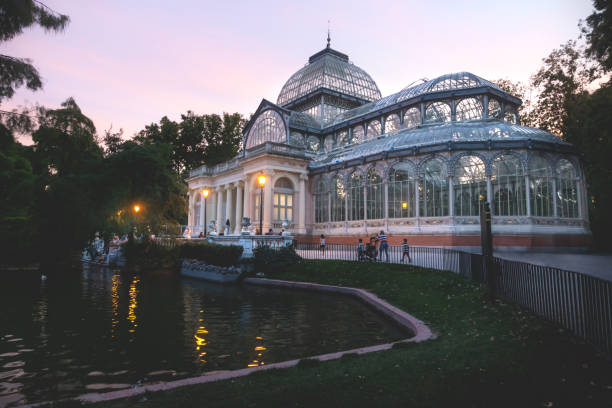 Crystal Palace in Retiro park along the pond during sunset, Madrid, Spain Crystal Palace in Retiro park along the pond during purple colored sunset, Madrid, Spain palacio de cristal photos stock pictures, royalty-free photos & images