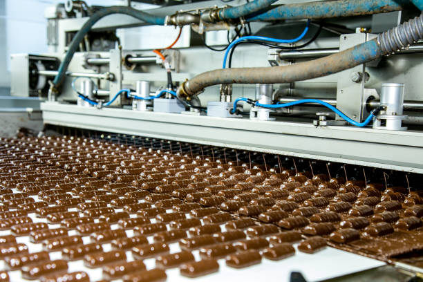 istock Sweets factory. Sweets production process. Conveyor belt with sweets on it. 1254284860