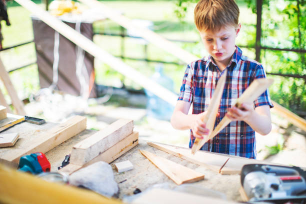istock Father and son building tree house at backyard 1254285787