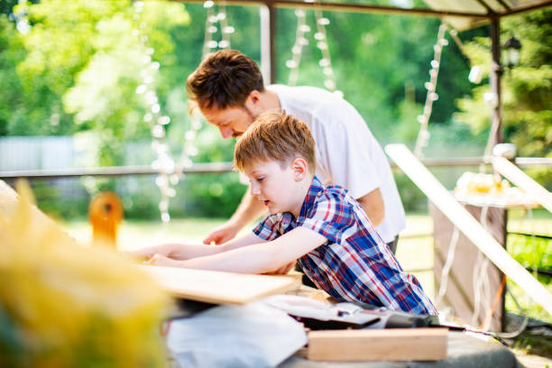 istock Father and son building tree house at backyard 1254285789