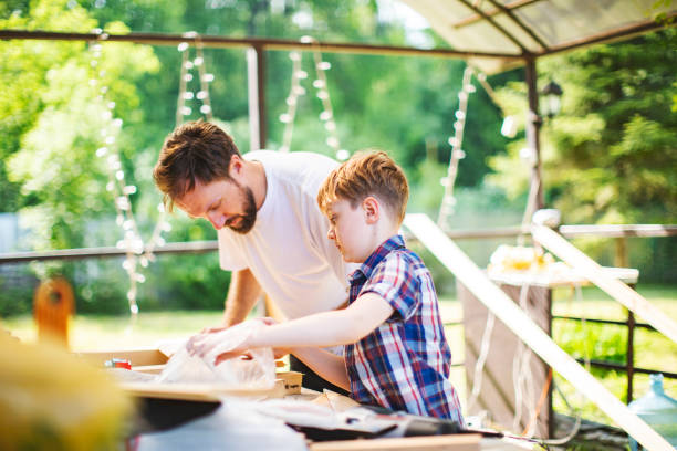 istock Father and son building tree house at backyard 1254285790