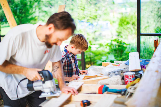 istock Father and son building tree house at backyard 1254285825
