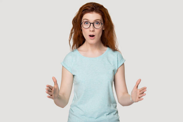 istock Shocked red-haired young woman showing big size. 1254296725