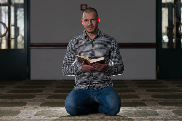 istock Young Muslim Guy Reading The Koran 1254297492