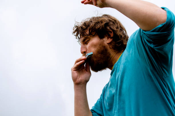 joven tocando música en harmonica instrument - blues harp fotografías e imágenes de stock