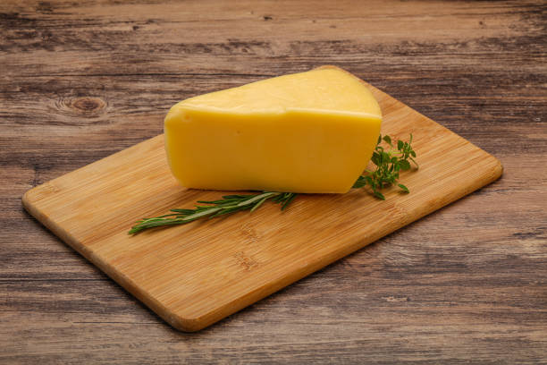 istock Hard cheese piece served rosemary 1254303959