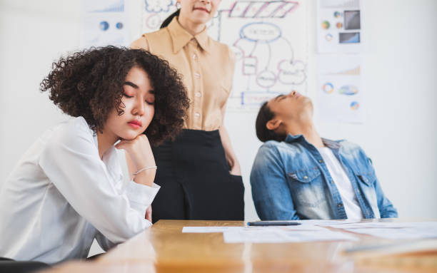 asian business people feel bored and tired/exhausted/sleepy while working in office - rudeness manager emotional stress asian ethnicity imagens e fotografias de stock