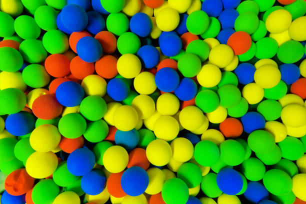 istock red, green , yellow and blue balls in the pit 1254310324
