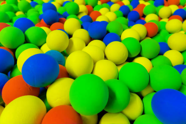 istock red, green , yellow and blue balls in the pit 1254310354