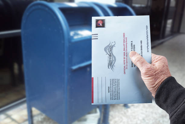 Vote by mail: Person mailing absentee ballot for voting Gualala, CA, July 4, 2020 - Person mailing United States absentee ballot for voting in an election by mail. absentee ballot photos stock pictures, royalty-free photos & images
