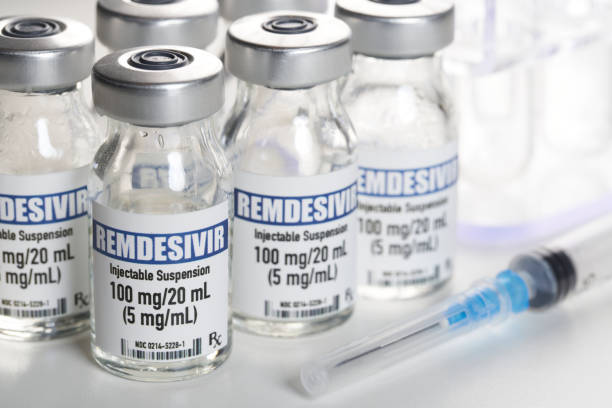 Remdesivir bottles with syringe for treatment of covid-19 Remdesivir, the only drug cleared to treat Covid-19. It is a generic drug and not a brand name. Fake lable created by photographer. antiviral drug stock pictures, royalty-free photos & images