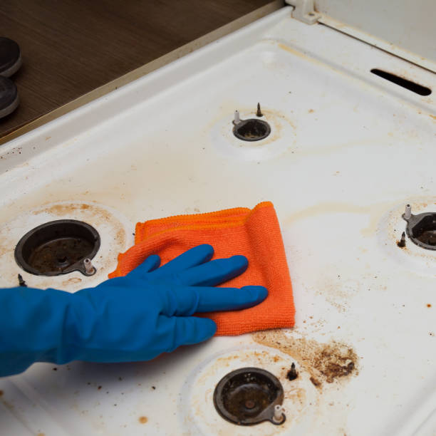 istock washing a dirty kitchen stove by a man in gloves 1254330880