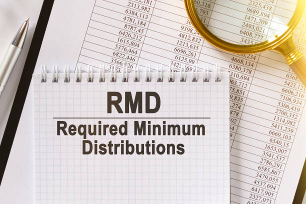 istock On the table are financial reports, a pen, a magnifying glass and a notebook with the inscription - RMD. 1254333185